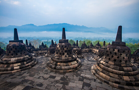 The stupas are lined up in the Borobudur Temple complex. Borobudur Temple is the largest Buddhist temple in the world, located in Magelang, Yogyakarta, Indonesia.