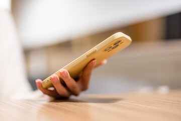 Woman hold with cellphone in cafe