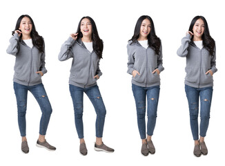 Obraz premium Full length portrait of young beautiful Asian woman in hoodie sweatshirt and blue jeans isolated over white background