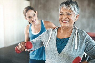 Physical therapy, dumbbell and fitness with old woman and personal trainer for support, health and...