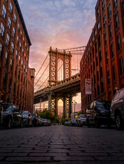 Sunrise over Manhattan Bridge, with Empire State Building in background, seen from DUMBO, NY