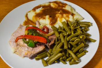 pork chop  top with sauteed onions and peppers
