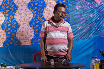 an Indian shop owner standing inside a shop