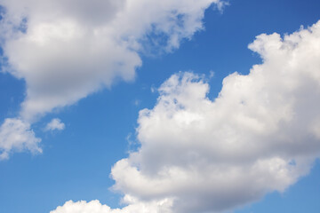Naklejka na ściany i meble Clouds in bright blue sky background or texture