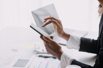 Businesswoman or accountant working Financial investment on calculator, calculate, analyze business and marketing growth on financial document data graph, Accounting, Economic, commercial concept.