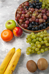 top view different grapes fresh fruits on the light white desk fruits fresh mellow juice summer