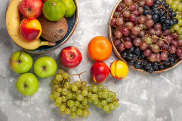 top view different grapes with other fresh fruits on light-white desk fruits fresh mellow juice summer