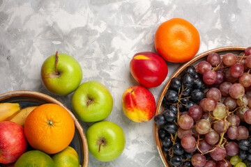 top view different grapes with other fruits on the light white desk fruit fresh mellow juice summer