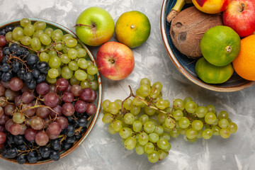 top view different grapes with other fruits on the light-white desk fruit fresh mellow juice summer
