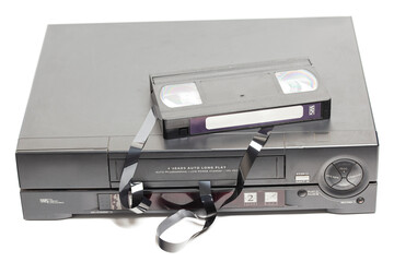 Retro video cassette recorders with broken VHS cassette with unwound tape isolated on white...