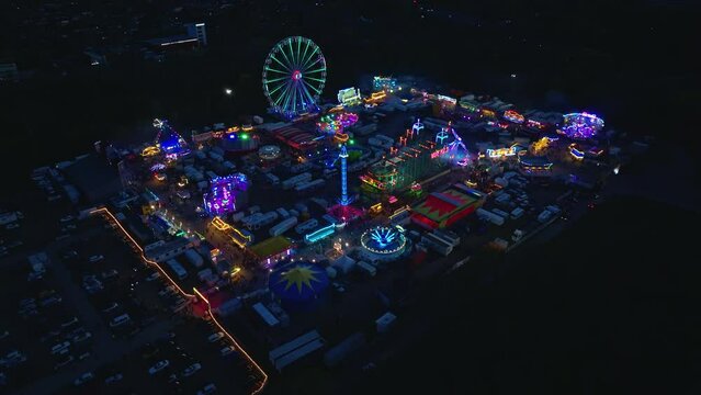 Drone shot of Amusement Park at night in the Zentrale Festplatz Berlin ( Central fairground Berlin ) , it is a site for holding outdoor events . 