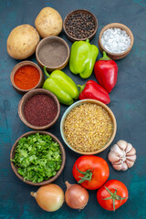 top view fresh vegetables with seasonings and greens on the dark-blue desk vegetable food meal dish greens