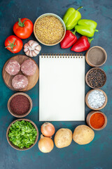 top view fresh vegetables with seasonings meat and greens on the dark-blue background vegetable food meal dish