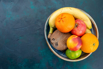 top view fruit composition tangerines bananas apples and coconut on dark blue desk fruit fresh vitamine exotic tropical