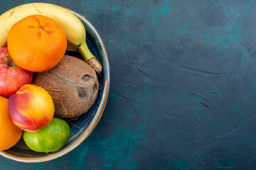 top view fruit composition tangerines bananas apples and coconut on dark-blue background fruit fresh vitamine exotic tropical - obrazy, fototapety, plakaty
