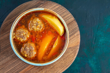 top view meat balls soup with potatoes inside round plate on dark-blue background food soup meat dish dinner vegetable