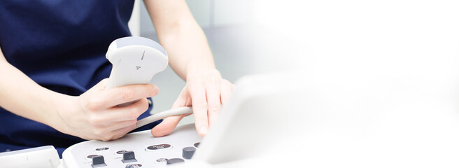 Female doctor sitting in office in a hospital doing ultrasound scanning diagnostic