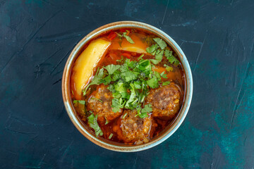 top view meat soup with meatballs greens and sliced potatoes on dark-blue desk food soup sauce vegetable dish