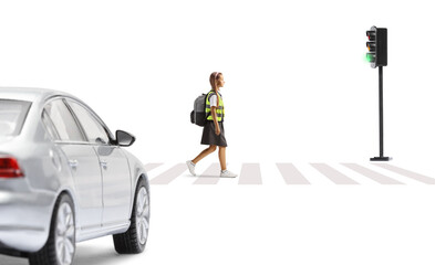 Car waiting and a schoolgirl with a safety vest crossing street at pedestrian crosswalk