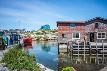 Red boat docked in the bay of a fishing village at Peggy's Cove, Nova Scotia.