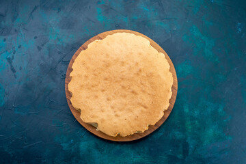 top view plain cake dough baked round formed on dark-blue background cake bake sweet sugar dough pie - obrazy, fototapety, plakaty