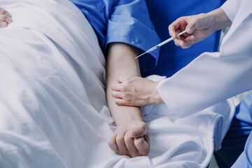 Doctor telling to patient woman the results of her medical tests. Doctor showing medical records to cancer patient in hospital ward. Senior doctor explaint the side effects of the intervention.