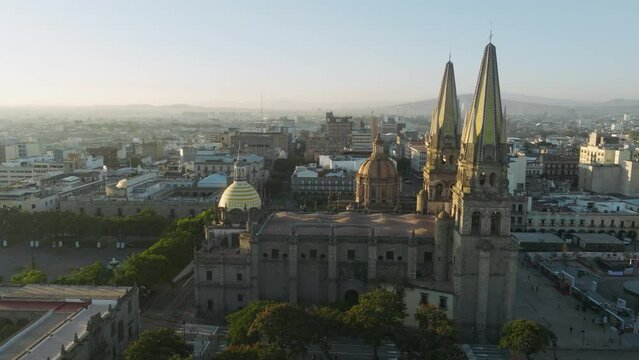 The Cathedral Basilica de la Asuncion de Maria Santisima, the Guadalajara Cathedral touristic landmark in Mexico 4K. Aerial of historical building main landmark in Guadalajara in golden sunrise light