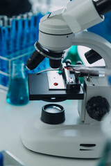 microscope with lab glassware, science laboratory research and development concept