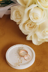 wedding rings and bouquet