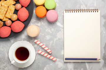 top view yummy cakes with crackers macarons and cup of tea on the grey-white desk cake biscuit cookie sugar sweet pie