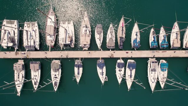 Top down aerial view of boats and yachts moored to jetty. Yachts in marina