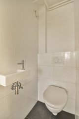 a white toilet in a small bathroom with tiled walls and tile on the floor, there is a mirror above it
