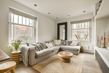 a living room with couches, coffee table and large window looking out onto the cityscapea view