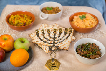 Shabbat set table with traditional food, fruits and menorah.