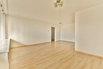 Fototapeta na wymiar an empty room with white walls and wood flooring on the right side, there is a mirror in the corner