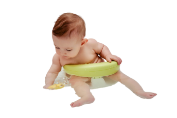 A happy infant baby bathes in water while sitting on a chair in a white tub, isolated on a white background. Toddler child plays with a yellow duck toy while bathing, six to seven months old