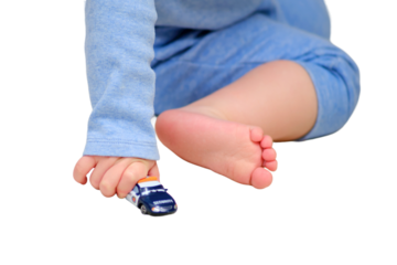 Toddler baby boy is playing with toy cars on the floor in the home room, isolated on a white background. A child plays with toys in the nursery. Kid aged one year and three months
