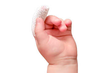 Baby s hand with a bandaged finger on a white isolated background, close-up. Injured index finger of a child wrapped in a white bandage. Kid boy aged one year and three months