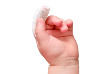 Baby s hand with a bandaged finger on a white isolated background, close-up. Injured index finger of a child wrapped in a white bandage. Kid boy aged one year and three months