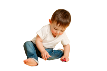 Toddler baby plays with toy cars on a studio isolated on a white background. Happy child in white t-shirt and blue jeans plays with toy cars. Kid aged one year and four months