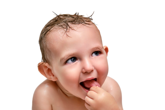 Portrait of a washing toddler baby boy in the bath, happy child, isolated on a white background. Smiling face of a child with wet hair in a white bathtub, kid aged one year