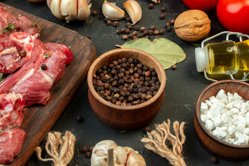 front view raw meat slice with fresh vegetables and seasonings on dark background salad cooking raw meat dish meal