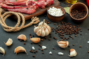 front view raw meat slice with fresh vegetables and seasonings on dark background salad cooking raw meat dish meal butcher