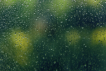 Raindrops on the window, close-up, blurred background.
