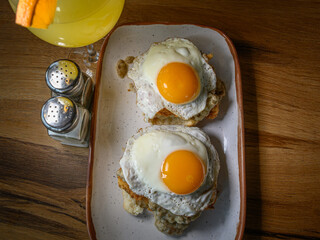 Over-Easy Eggs on Chicken Biscuits, with Gravy and a Mimosa