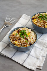 Homemade Fried Rice with Bacon and Egg in a Bowl, side view.