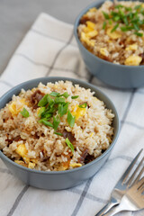 Homemade Fried Rice with Bacon and Egg in a Bowl, side view.