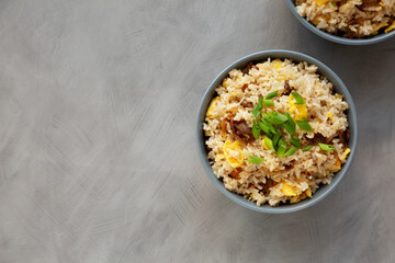 Homemade Fried Rice with Bacon and Egg in a Bowl, top view. Flat lay, overhead, from above. Copy space.