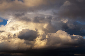 Storm cloudy dramatic sky with dark rain grey cumulus cloud in sunlight background texture, thunderstorm, heaven	
