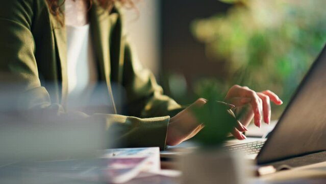 Girl office worker typing laptop in cabinet close up. Business woman working.